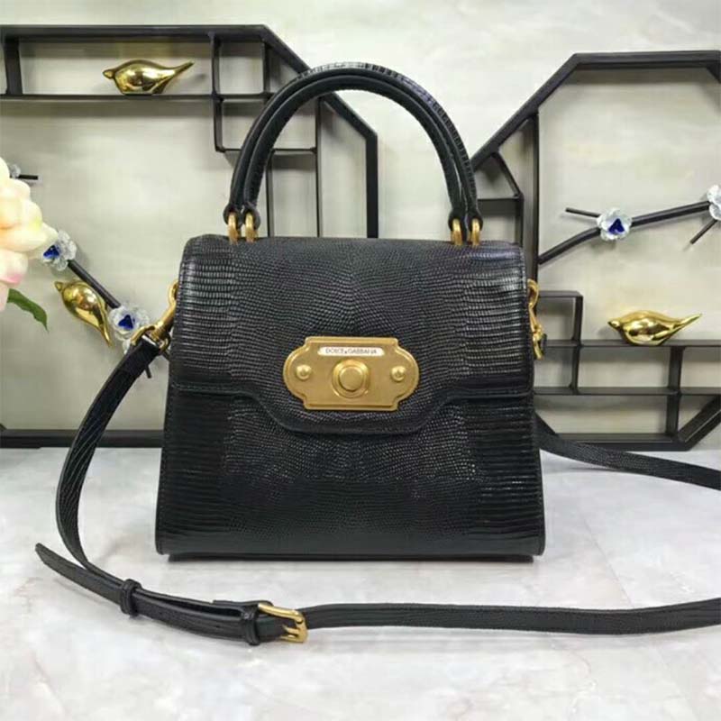 Close-up of gold D&G hardware on black leather handbag