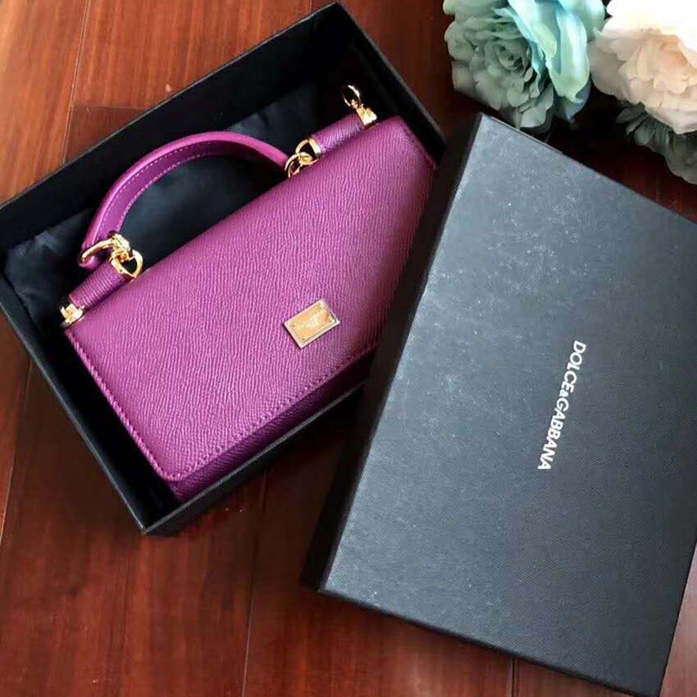 Side angle showing adjustable strap of Min Von Bag in purple leather