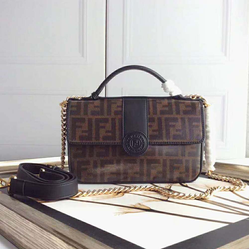 Close-up of gold Double F logo on brown leather Fendi bag