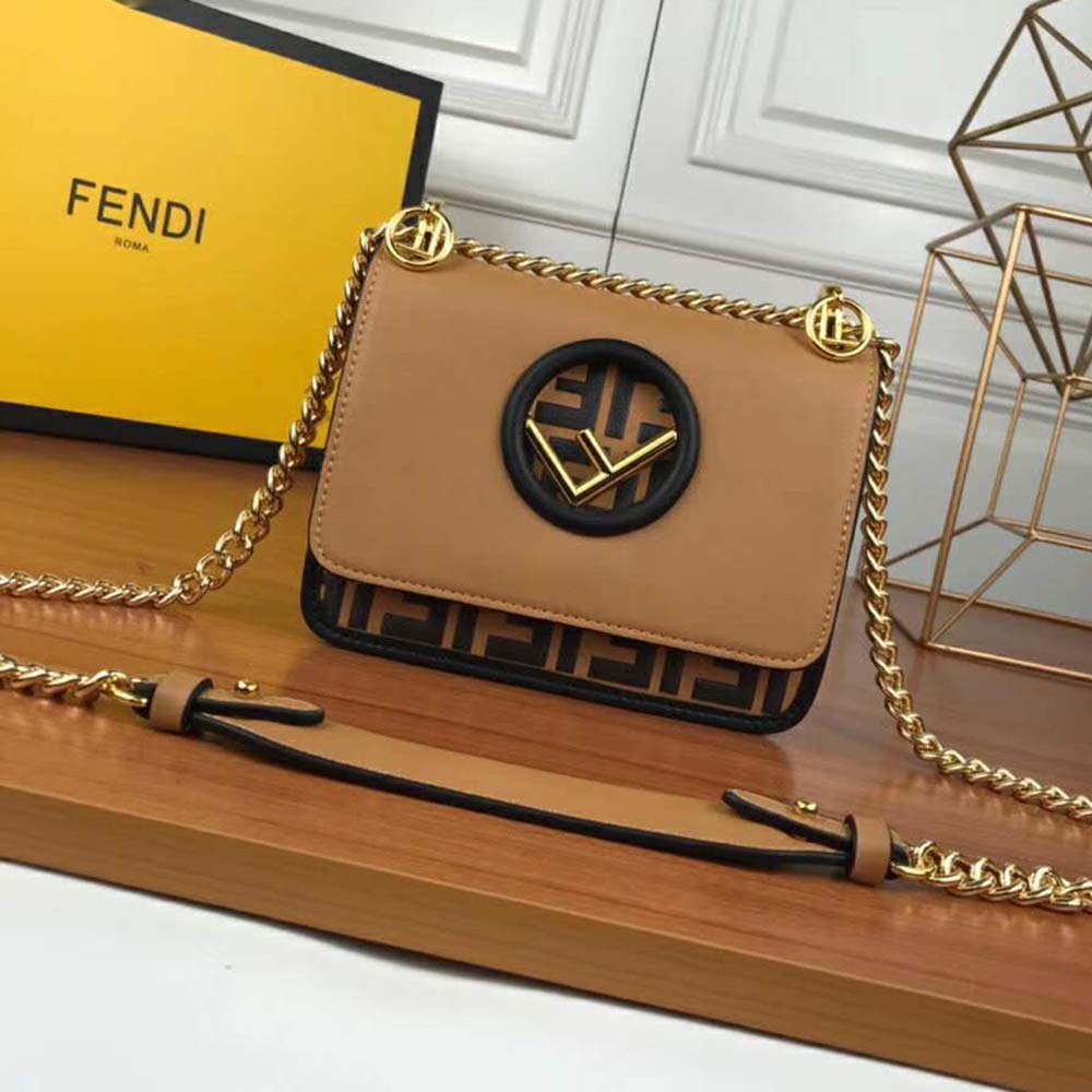 Close-up detail of gold-tone Fendi logo on mini-bag flap