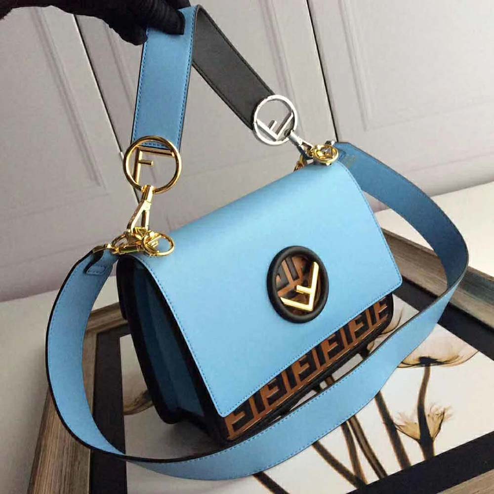 Close-up of Fendi signature gold hardware on blue Kan I F leather bag