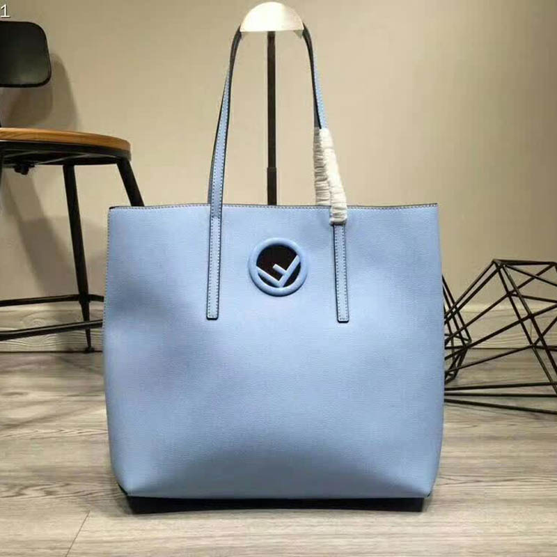 Close-up of blue calf leather texture and Fendi logo on shopper bag