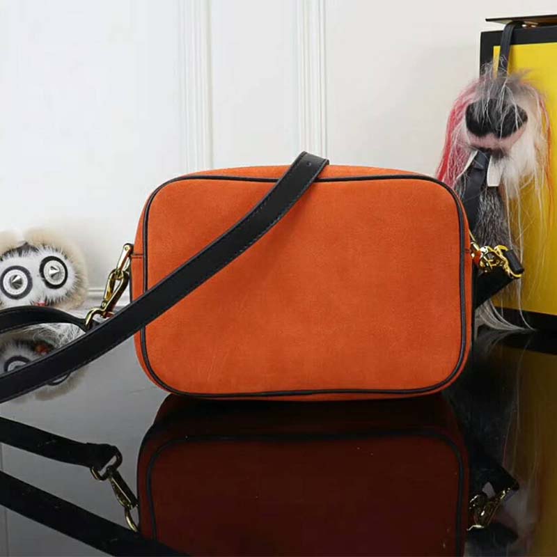 Side angle showing compact silhouette and zip closure of Fendi mini bag