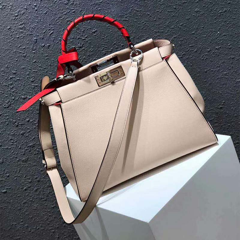 Side angle showing the dual-compartment design of Fendi white bag