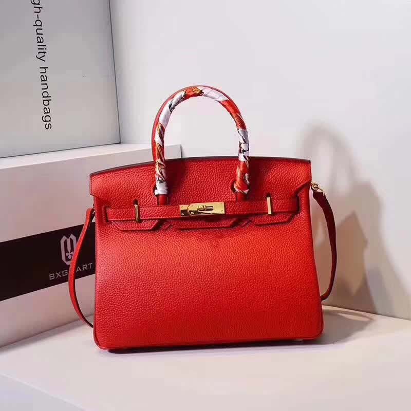 Close-up of gold hardware and textured red Togo leather on Hermes Birkin 25