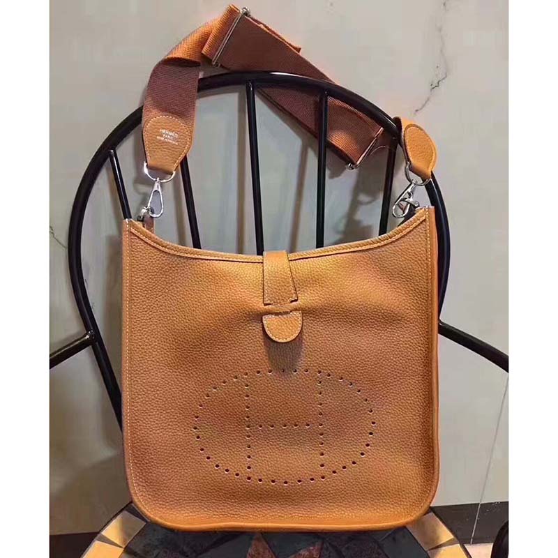 Side angle showing adjustable strap and silver hardware on Hermes Evelyne III 33