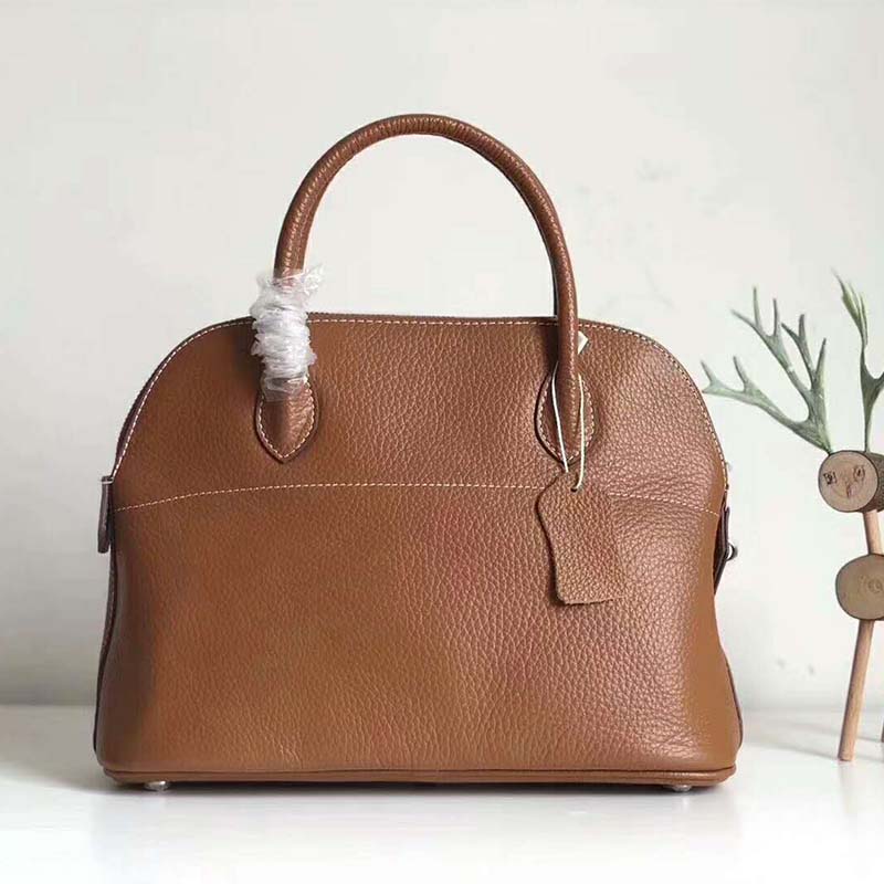 Side profile showing curved silhouette of Hermes Women Bolide 31 bag