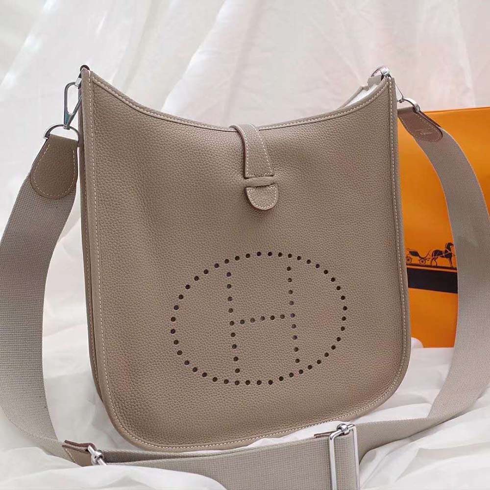 Side angle highlighting adjustable shoulder strap on Hermes Women Evelyne III 29 Bag-Brown