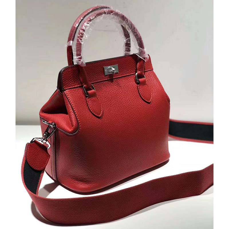 Side angle showcasing silhouette and adjustable strap of Hermes Women Toolbox 26 Bag