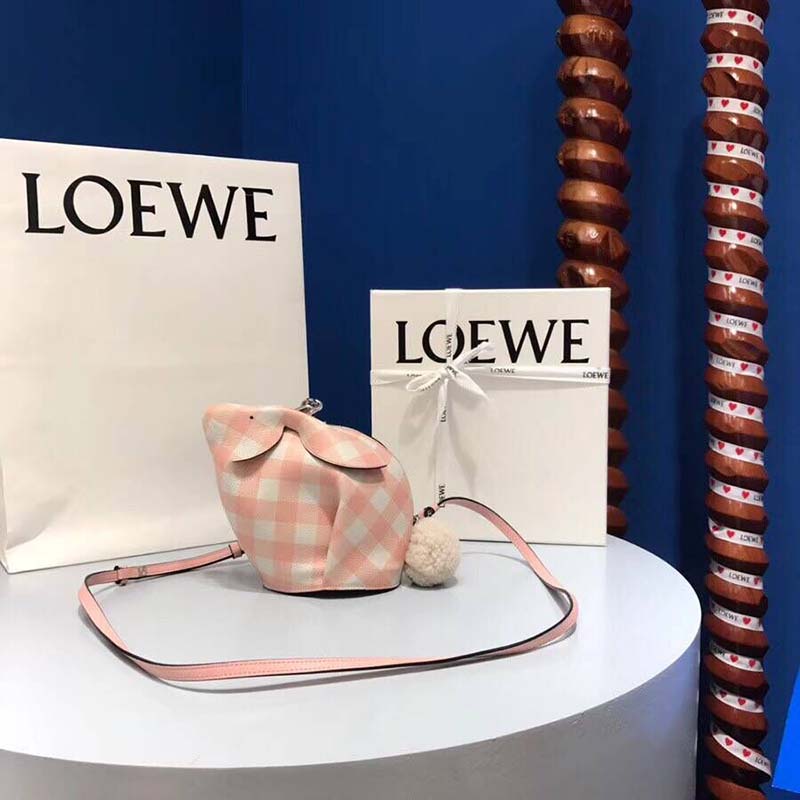 Side angle showing adjustable strap and compact silhouette Loewe bag