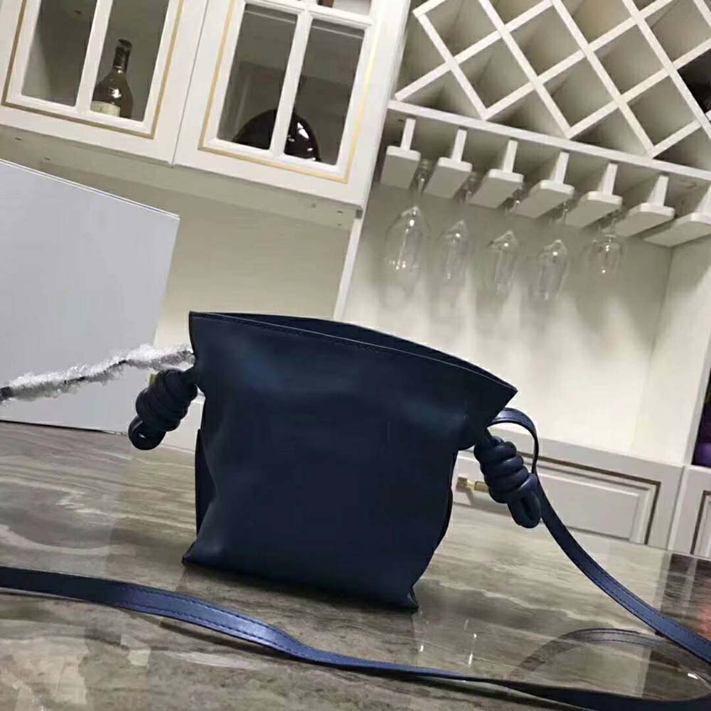 Side profile showing the flap closure and silver hardware on Loewe Flamenco Knot Mini Bag