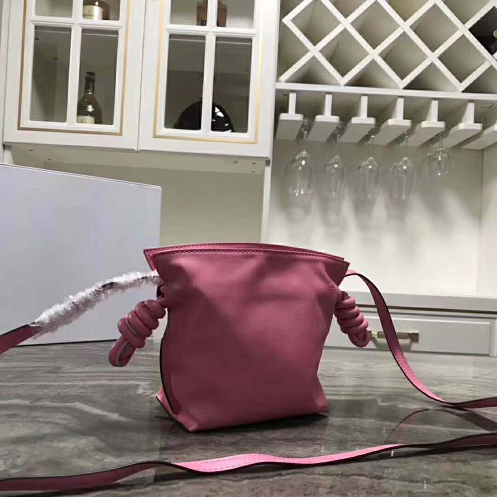 Side angle showing compact silhouette of Loewe Women Flamenco Knot Mini Bag pink