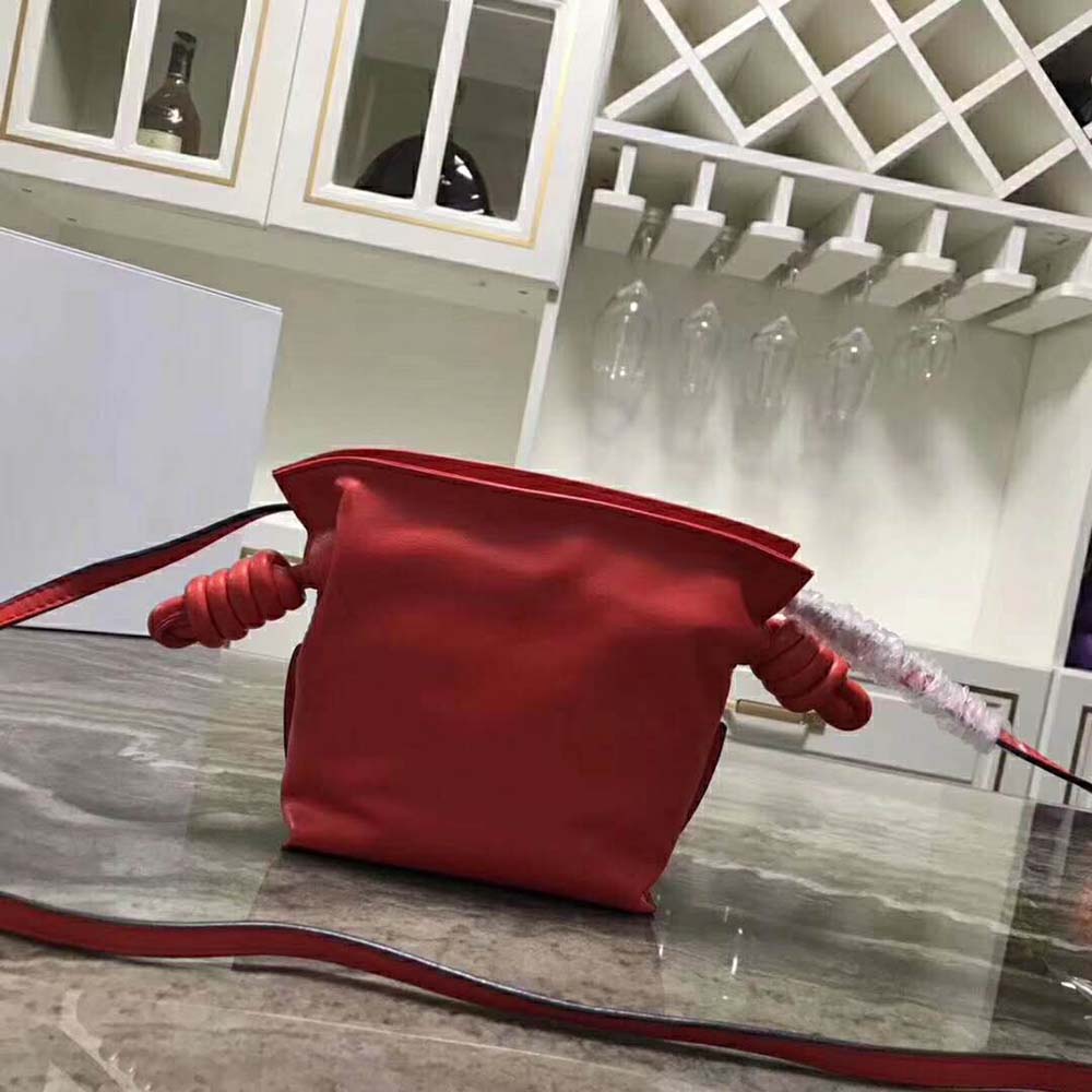 Close-up of flamenco knot detail on red Loewe mini bag