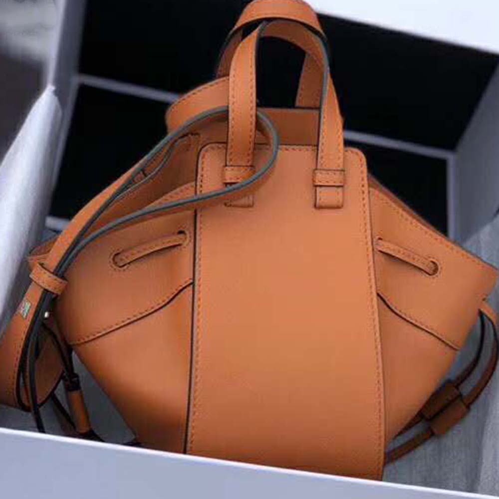 Side angle showing flexible silhouette of Loewe Women Hammock Dw Mini Bag