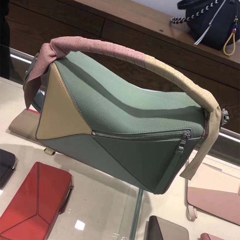 Side profile showing structured silhouette of Loewe Women Puzzle Wrap Bag