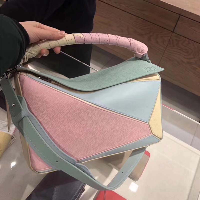 Close-up on gold hardware and flap closure of Loewe Puzzle Wrap Bag