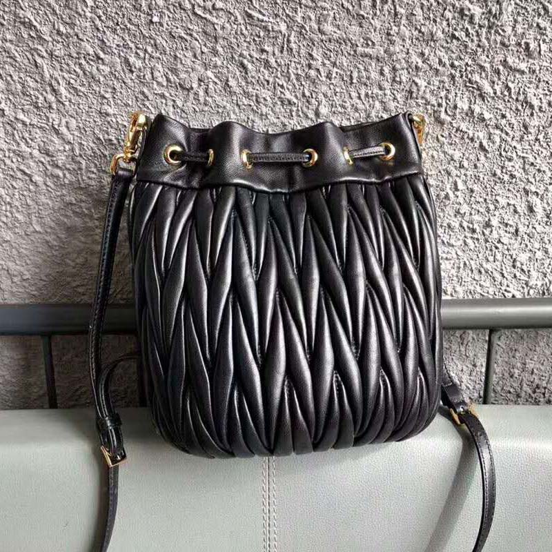 Side angle showing adjustable strap of Miu Miu Women Matelasse Leather Bag-Black