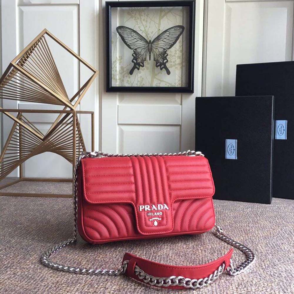 Close-up of Prada Diagramme Leather Shoulder Bag-Red showing silver triangle logo