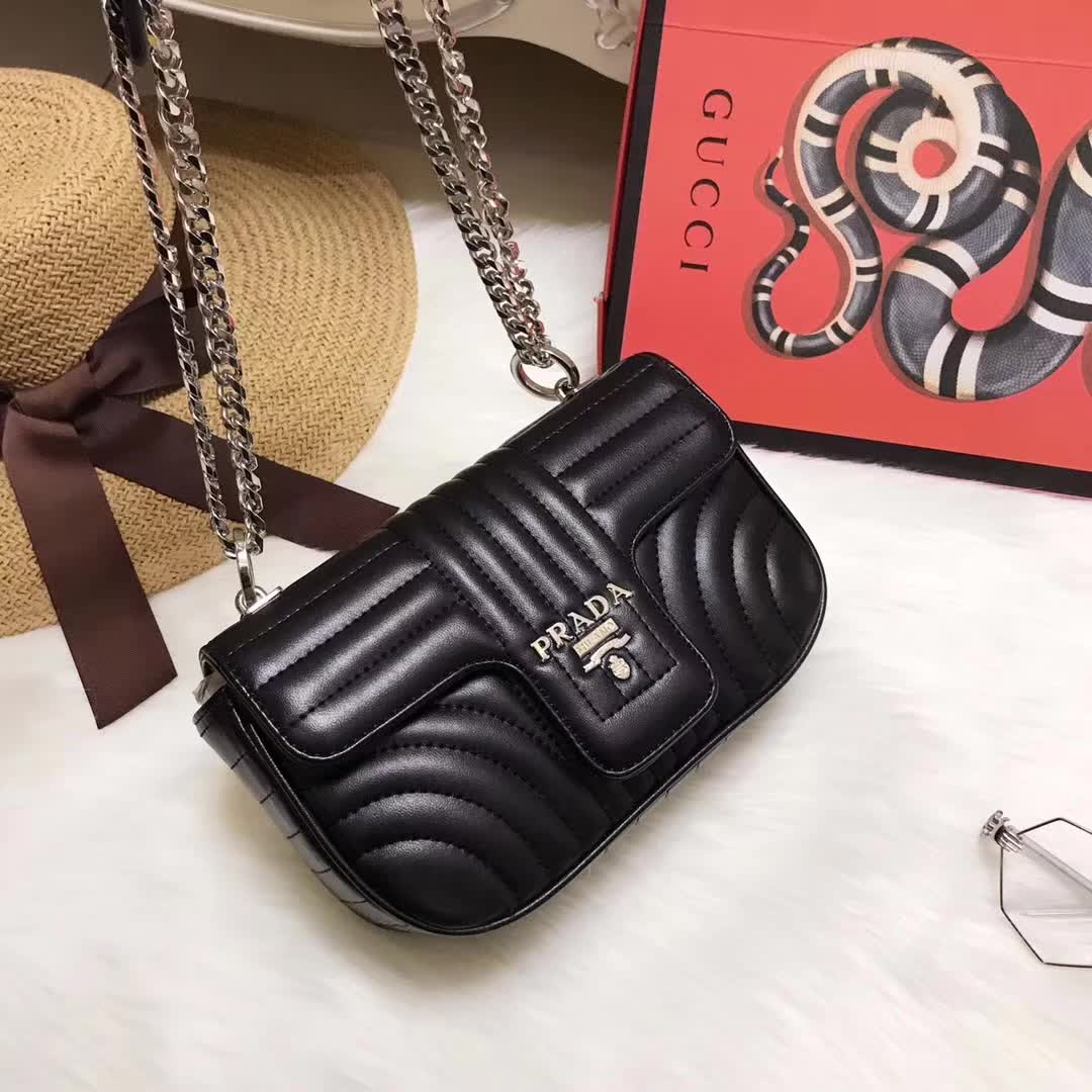 Close-up on silver hardware and chevron stitching of Prada Diagramme bag