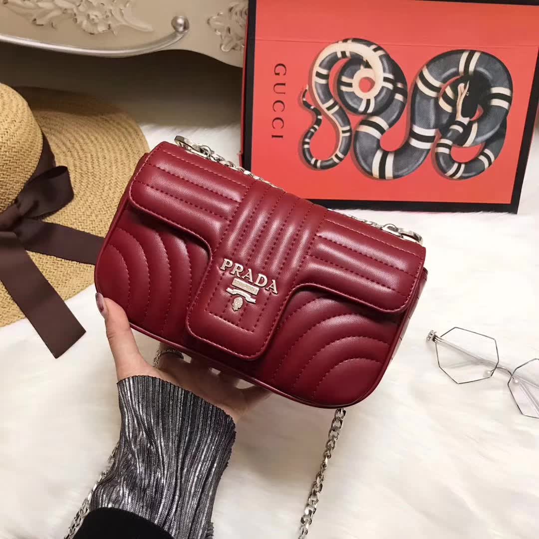 Close-up of maroon quilted leather and gold closure on Prada Diagramme bag