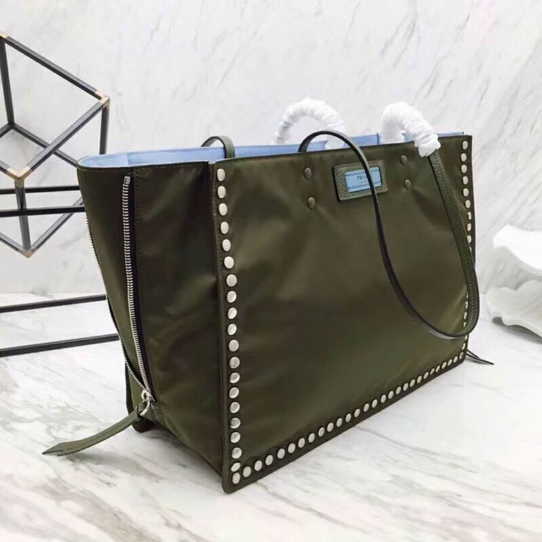 Side angle showing silhouette and olive fabric of Prada Etiquette Fabric Tote