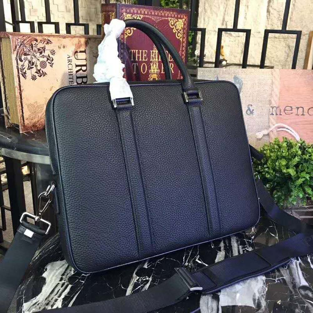 Side profile showing structured silhouette of Prada Men black briefcase