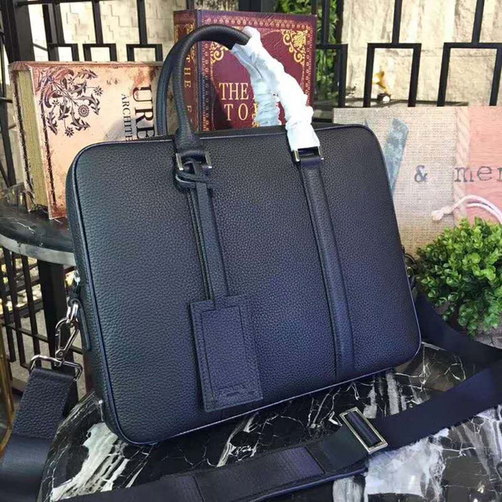 Close-up of silver hardware and Prada embossed logo on briefcase