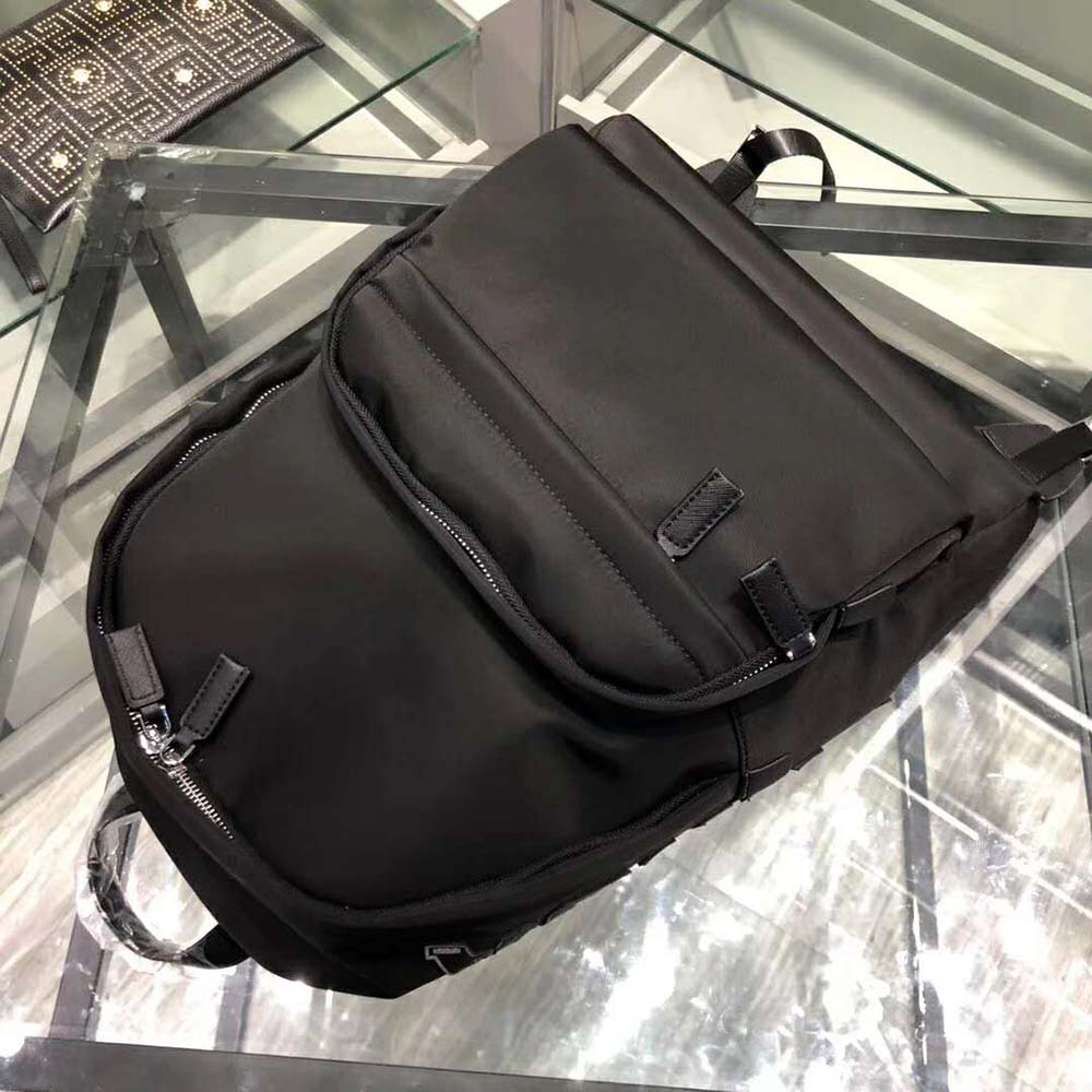 Side angle showing adjustable straps of Prada backpack in black