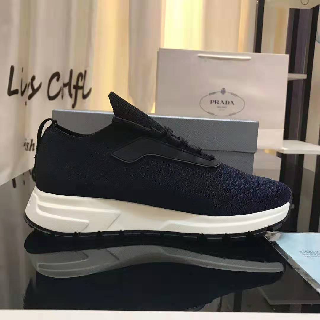 Close-up of navy knit texture and lace-up detail on Prada Men PRAX 01 Sneakers