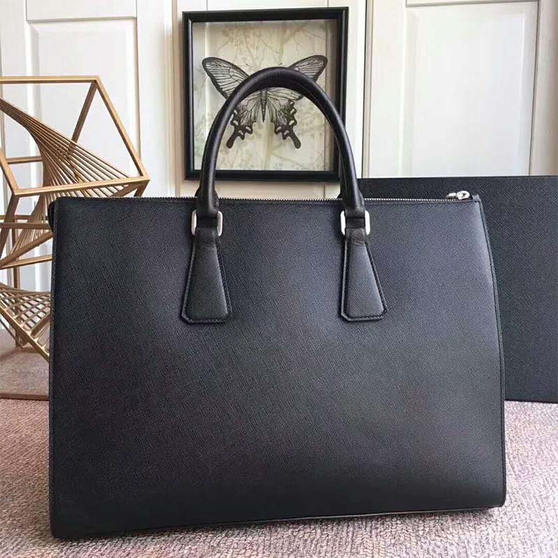 Close-up of black Saffiano leather texture and silver hardware on Prada tote