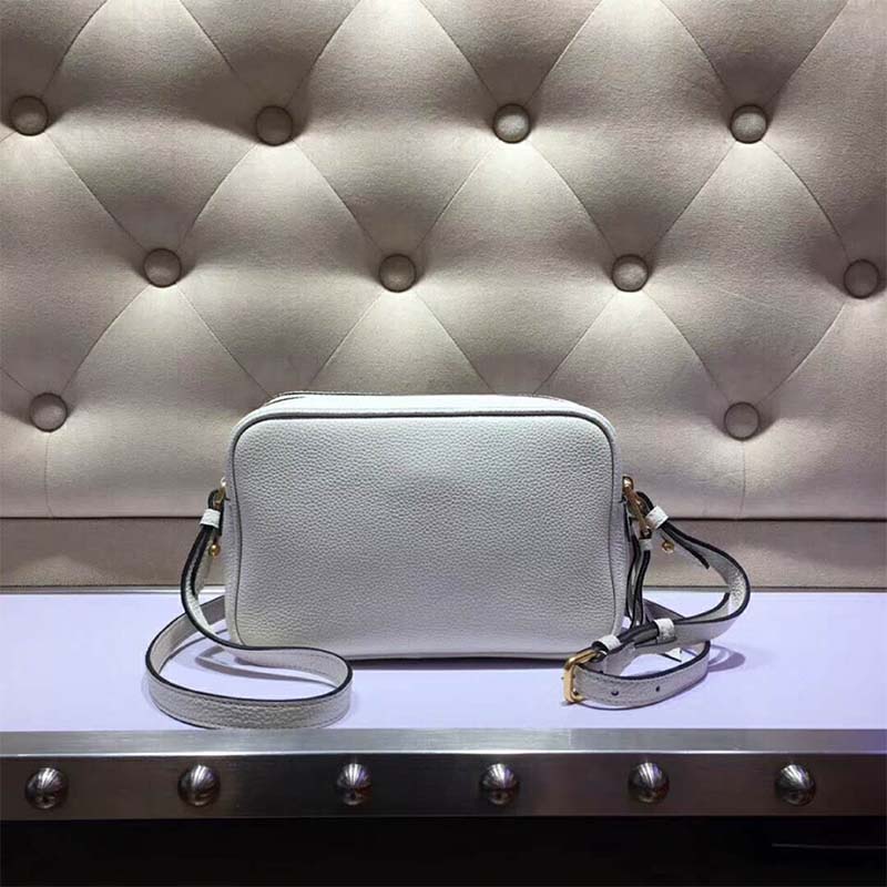 Close-up of silver Prada logo hardware on white calf leather bag