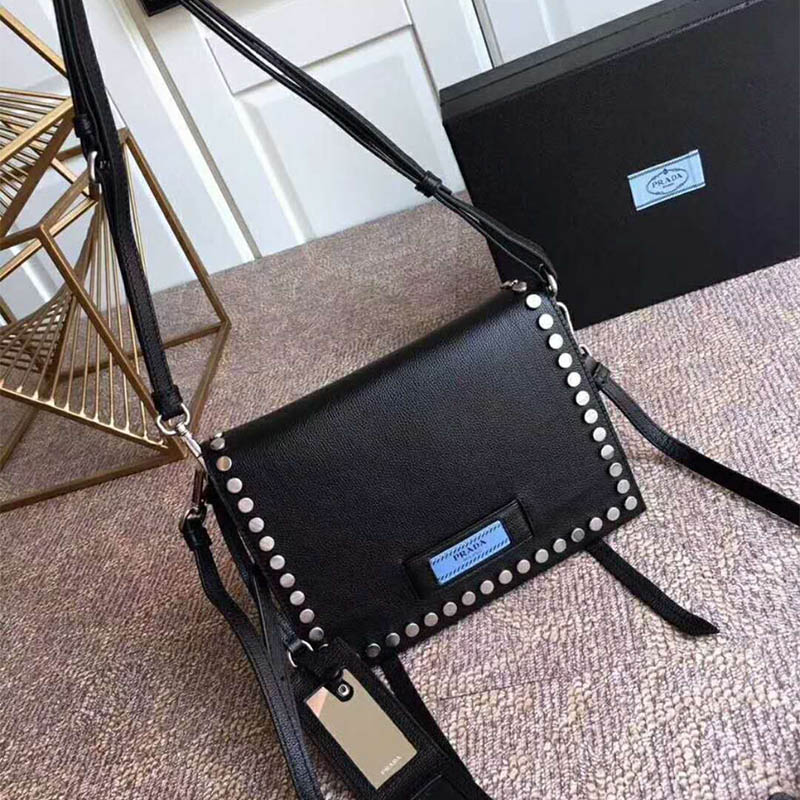 Side angle showing silhouette and strap of Prada Women Etiquette Bag