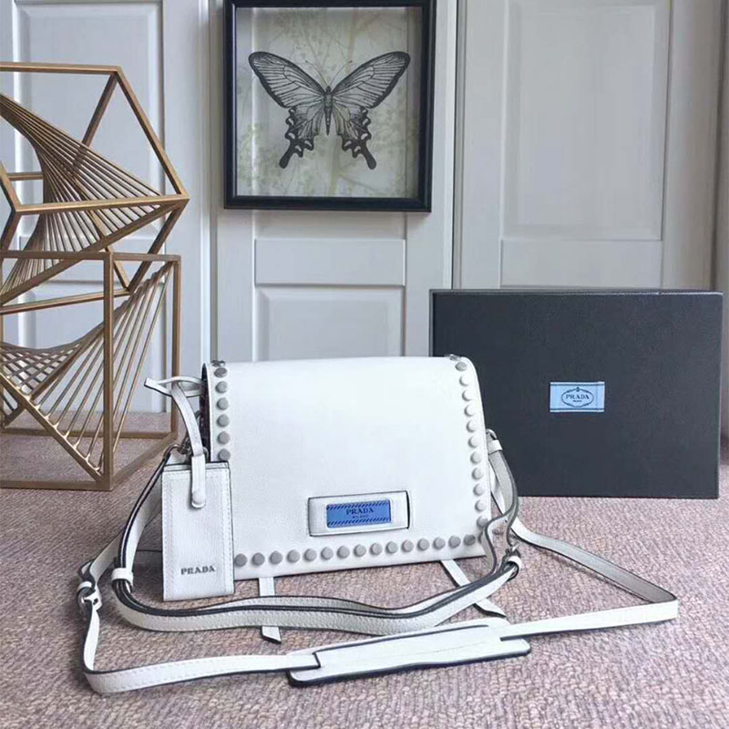 Close-up on silver hardware and smooth white leather of Prada Women Etiquette Bag