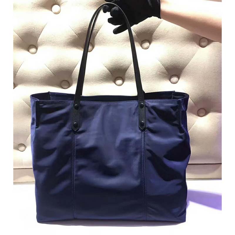 Side profile showing spacious silhouette of Prada Women Large Etiquette Nylon Bag-Black