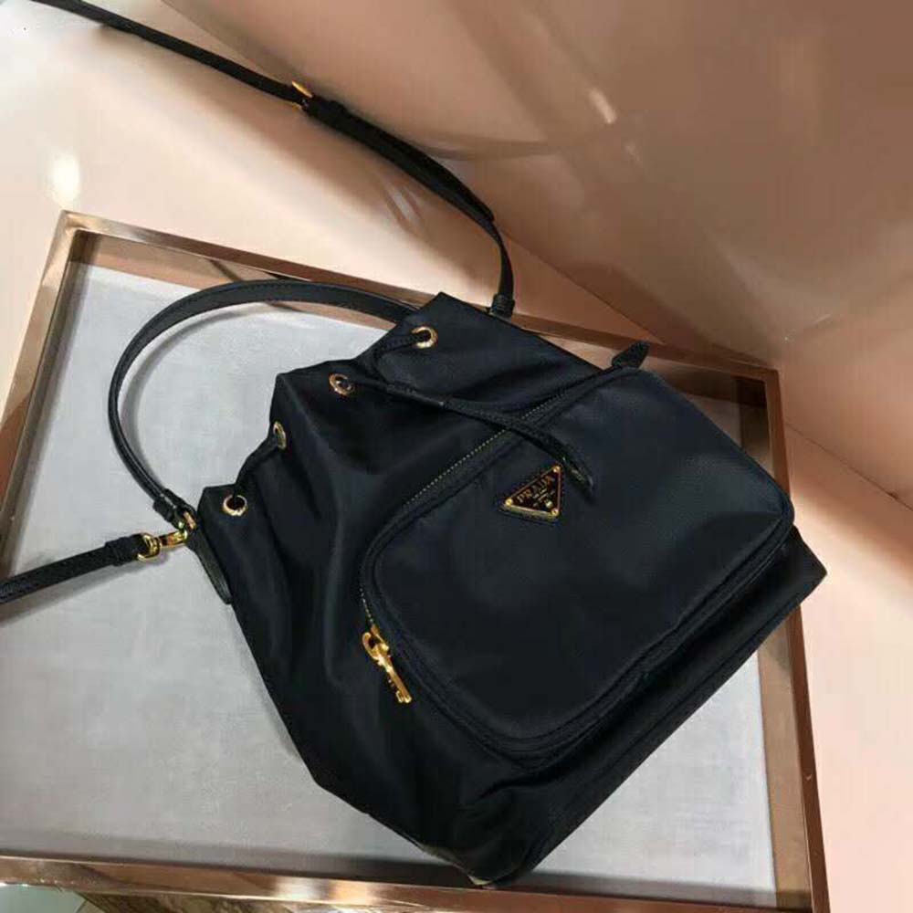 Side angle showing adjustable strap and zip closure on Prada bag
