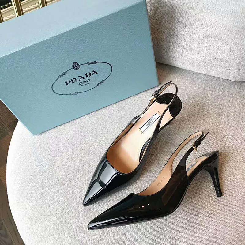 Close-up of black leather and slingback strap detail on Prada pumps