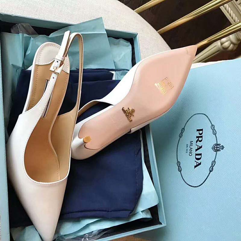 Rear view showing adjustable slingback strap and heel of Prada white pumps