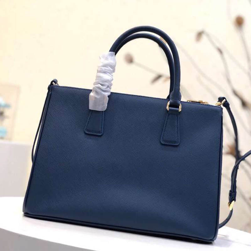 Side profile showing structured silhouette of Prada Women Prada Galleria Bag Blue