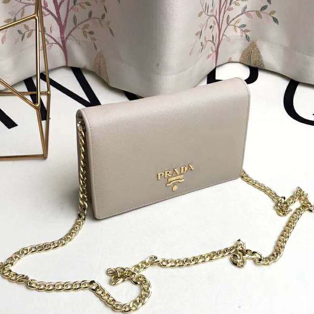 Close-up of gold-tone closure on Prada Women Saffiano Leather Shoulder Bag-Beige