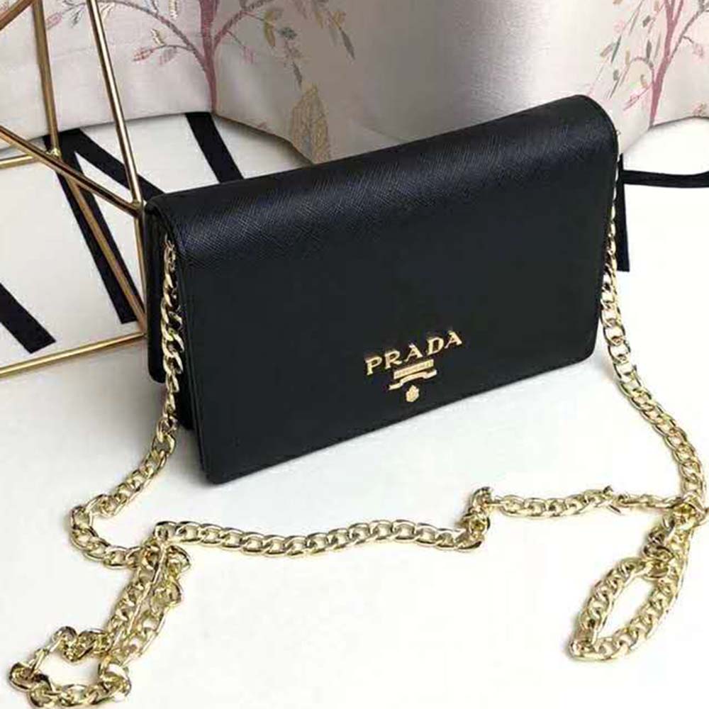 Close-up on Prada logo and silver hardware on shoulder bag