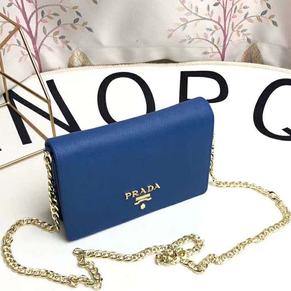 Close-up of navy Saffiano leather texture and silver hardware on Prada bag