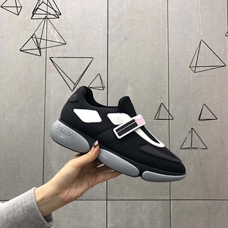 Close-up of Prada logo embossed on black Cloudbust sneaker sole