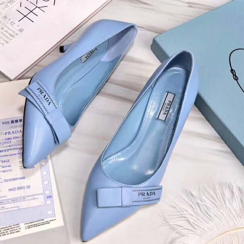 Back angle showing slender 55mm heel on Prada leather pumps