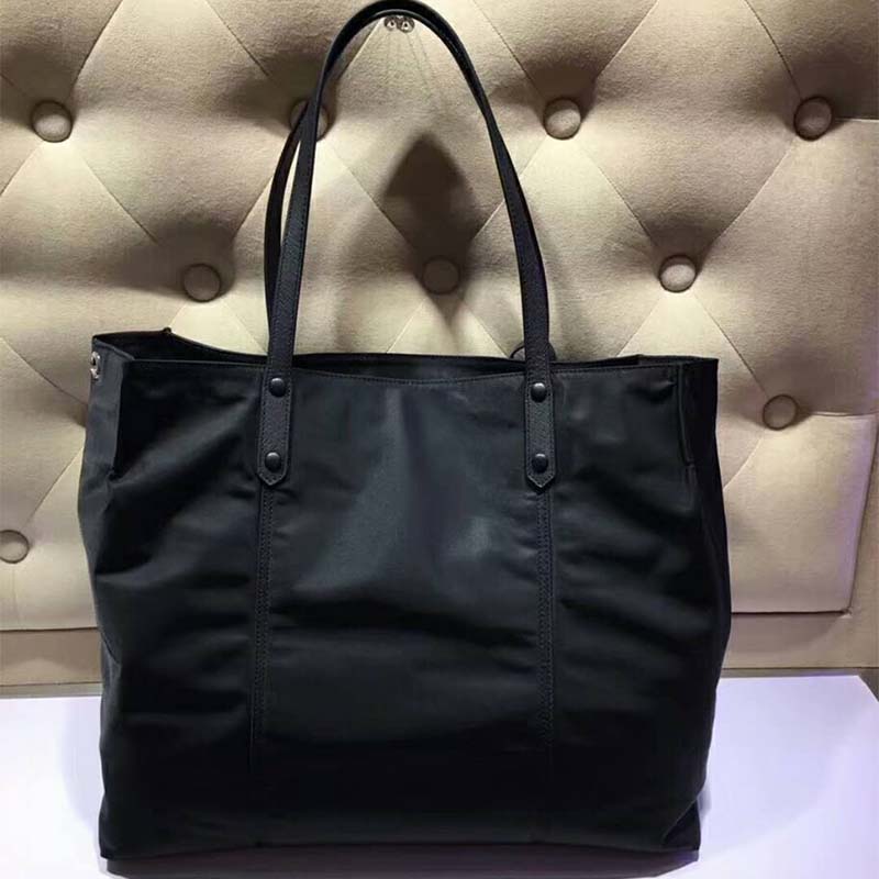 Side angle showing slim silhouette of Prada Women Small Etiquette Nylon Bag-Black