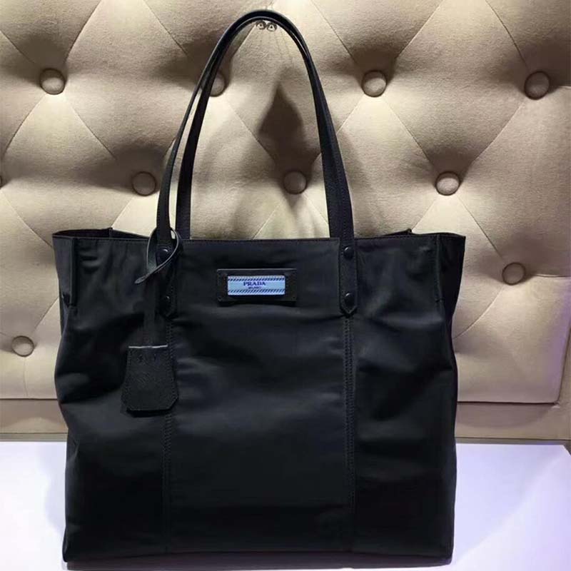 Close-up of silver-tone Prada logo on Small Etiquette Nylon Bag-Black