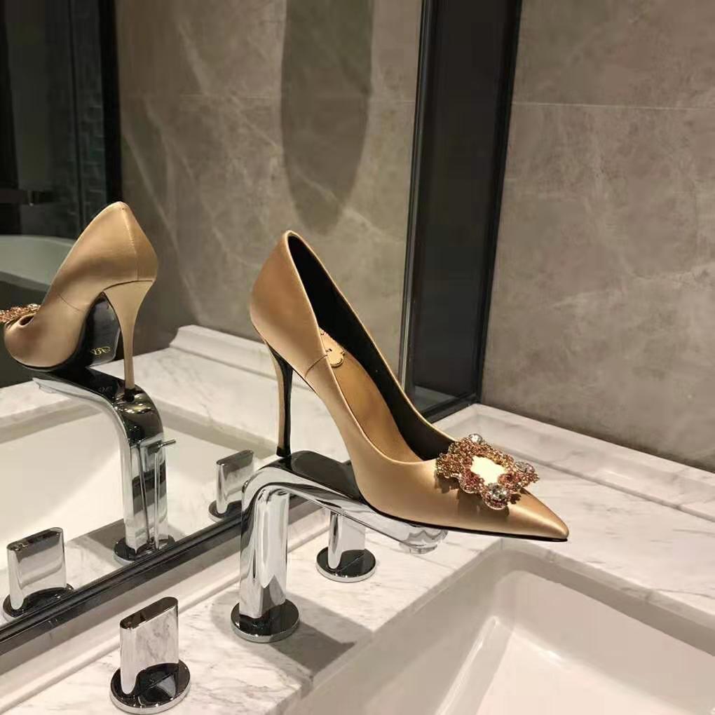 Close-up of sparkling flower strass buckle on Roger Vivier pumps