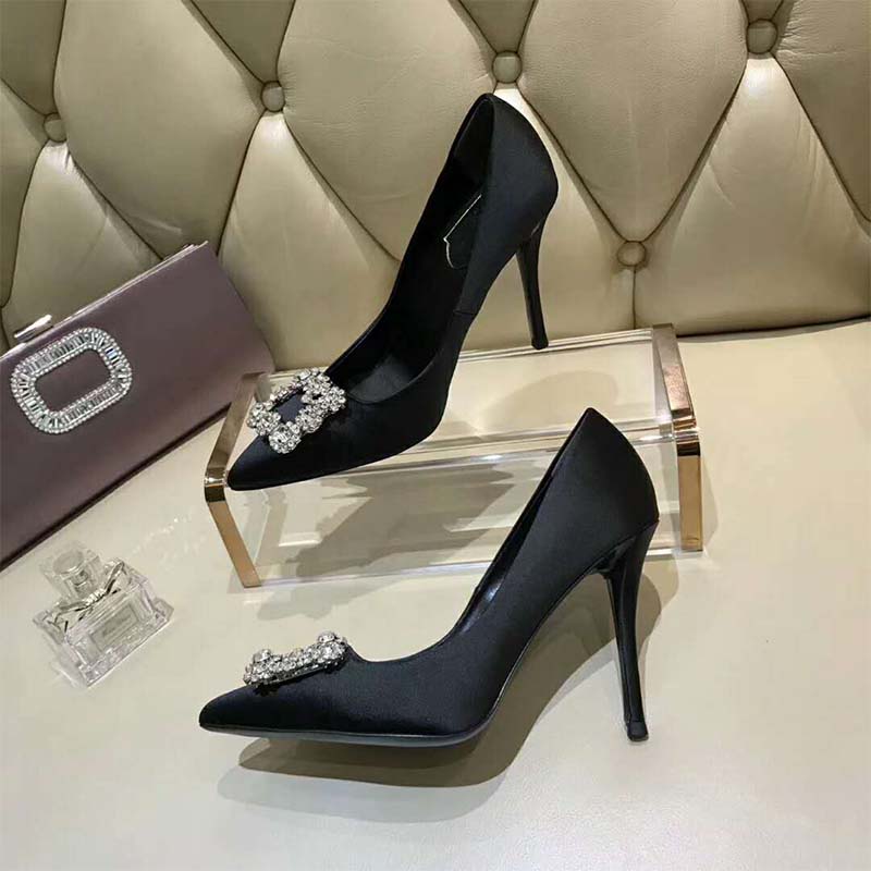 Close-up of crystal flower buckle on Roger Vivier Pumps in black