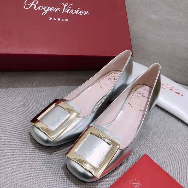 Top-down detail showing metallic leather and studs of Roger Vivier ballerinas