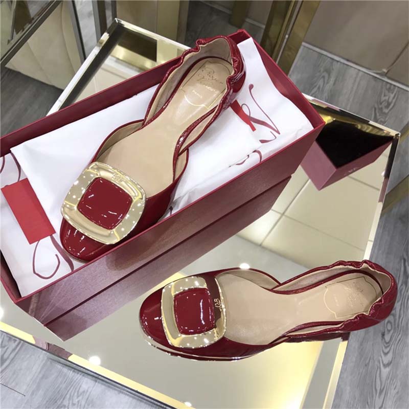 Close-up of signature square buckle on Roger Vivier red patent ballerinas