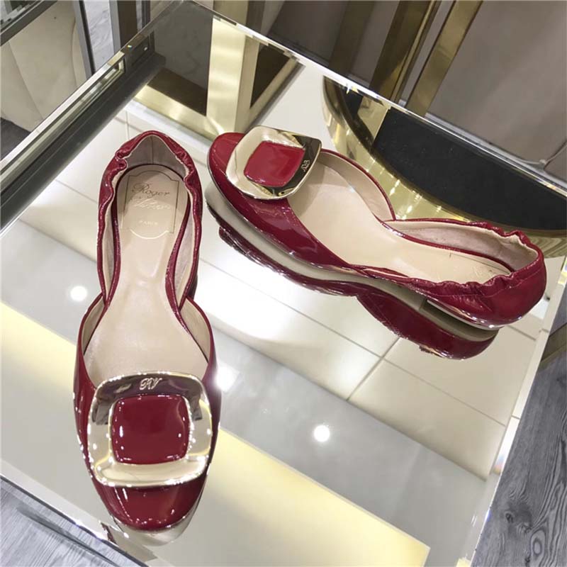 Side profile showing sleek silhouette of Roger Vivier patent leather ballerinas